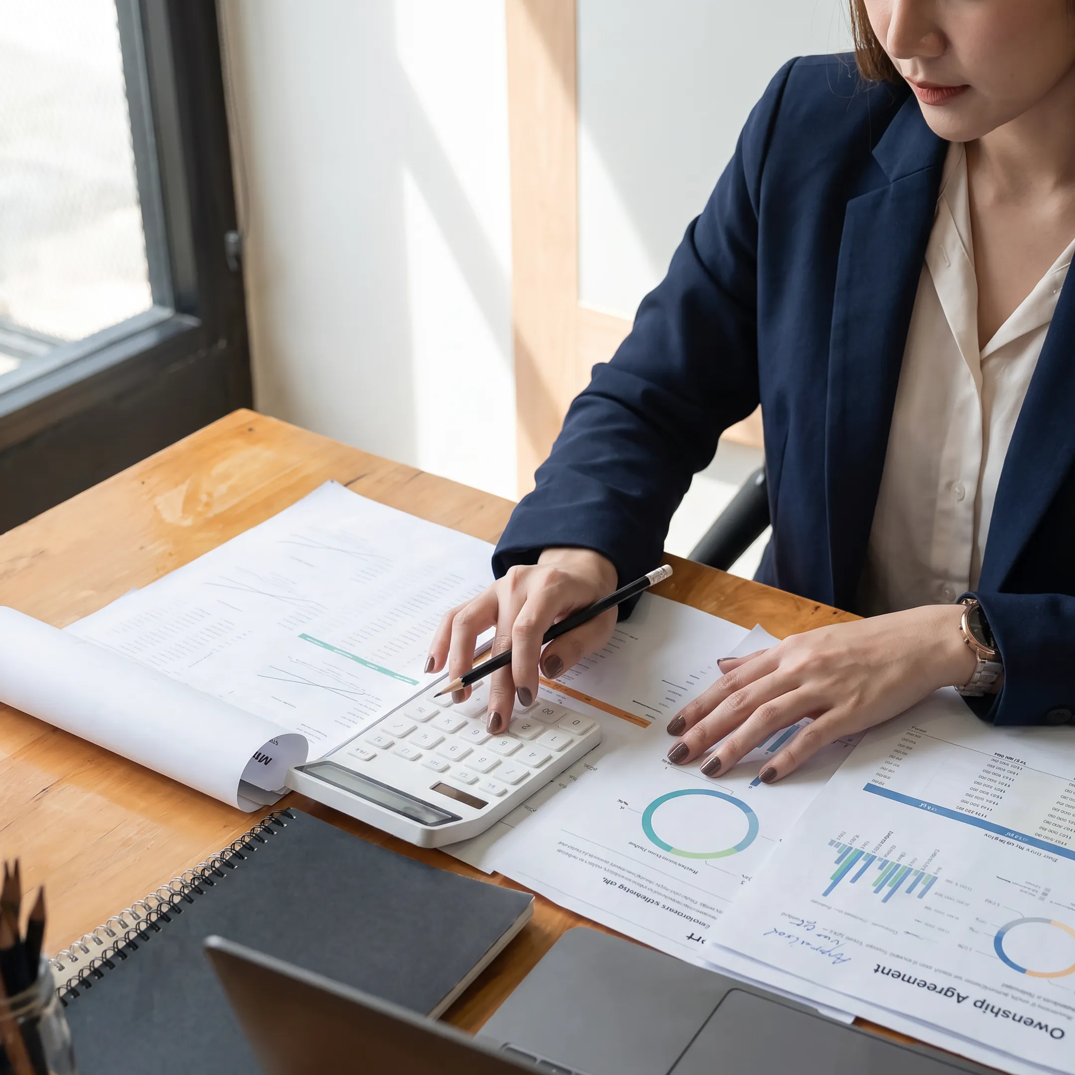 Valuation professional reviewing business financial documents at a desk
