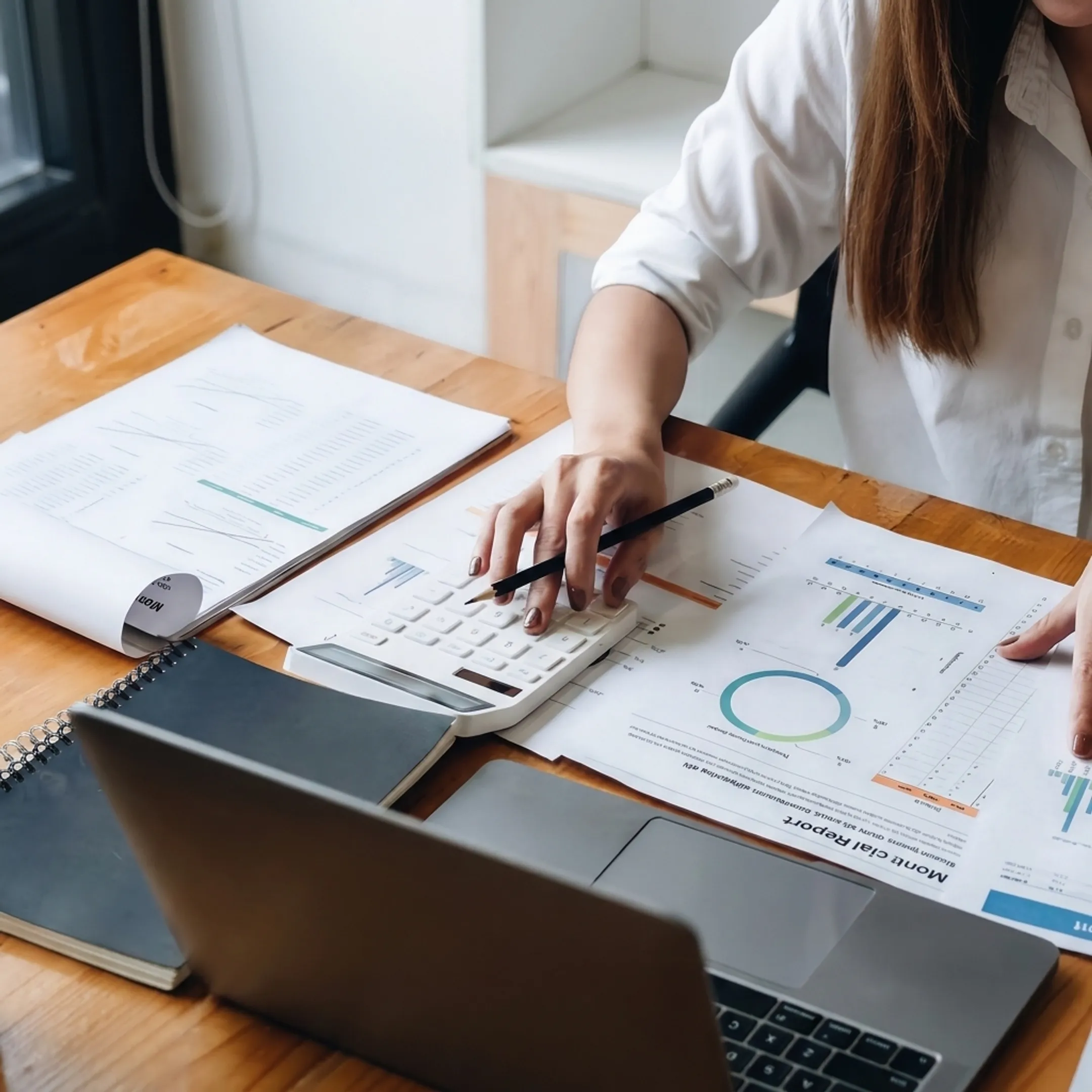 Valuation professional analyzing business financial data and ownership documents