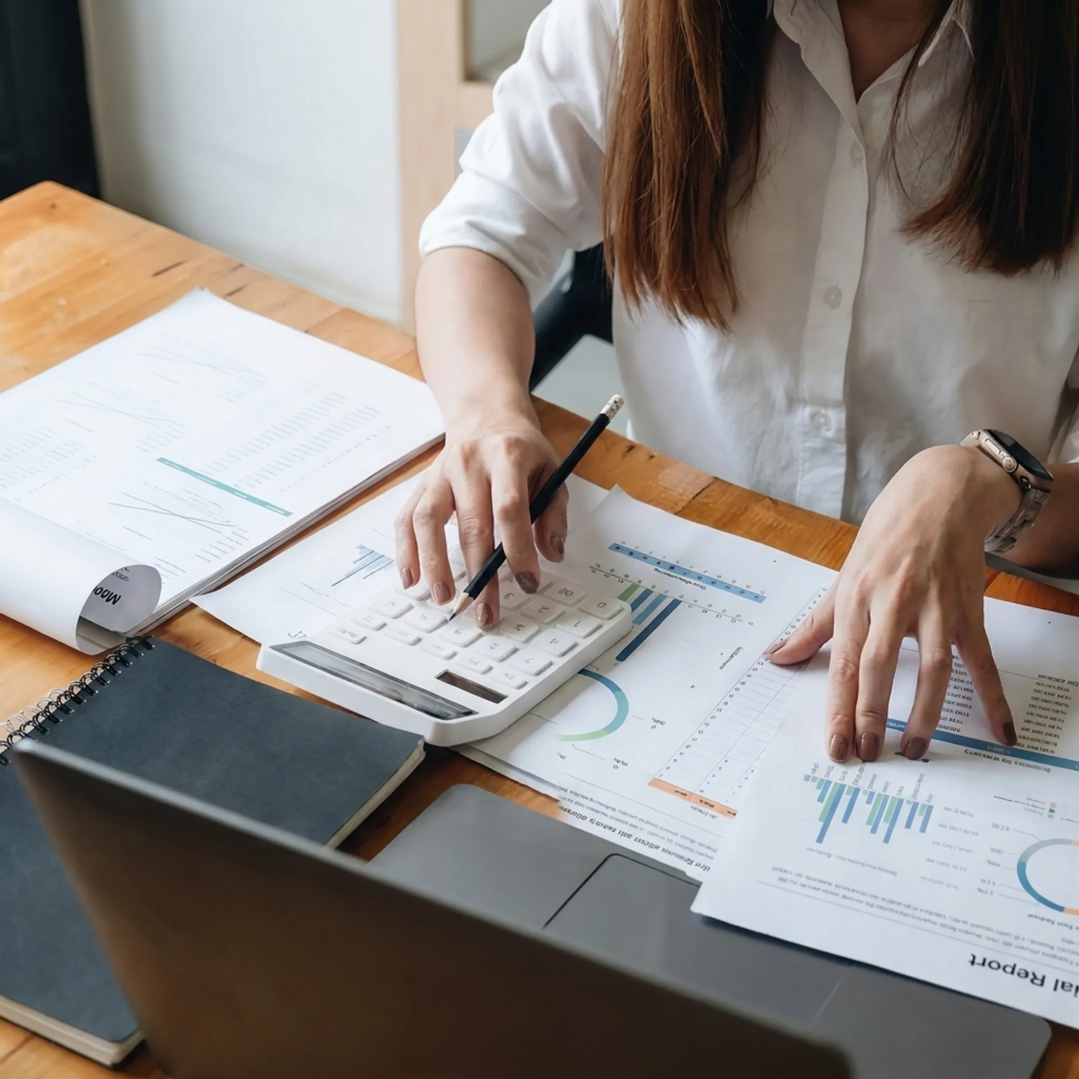 Business valuation report and financial analysis documents on a professional desk