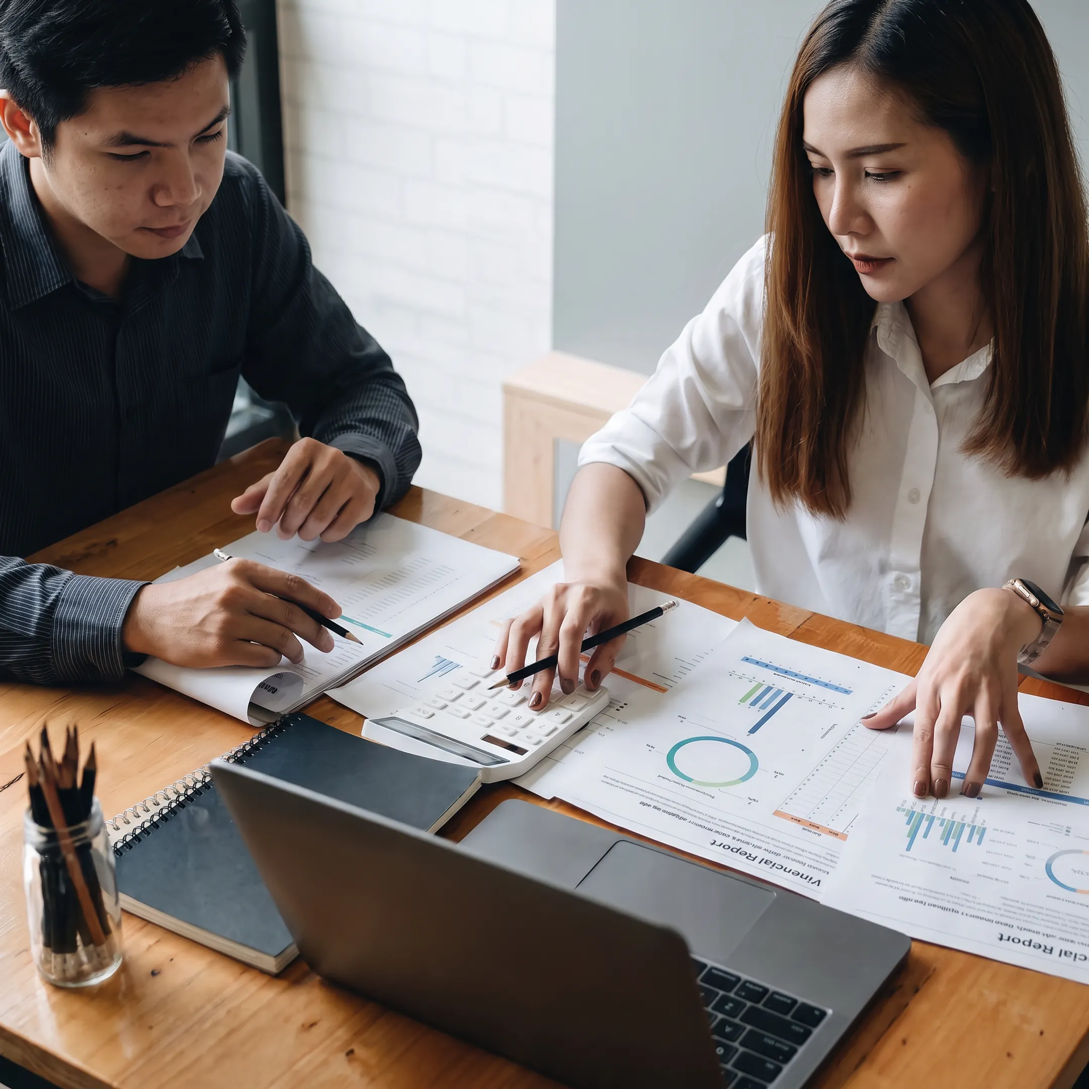 Valuation professional reviewing business financial documents with a client