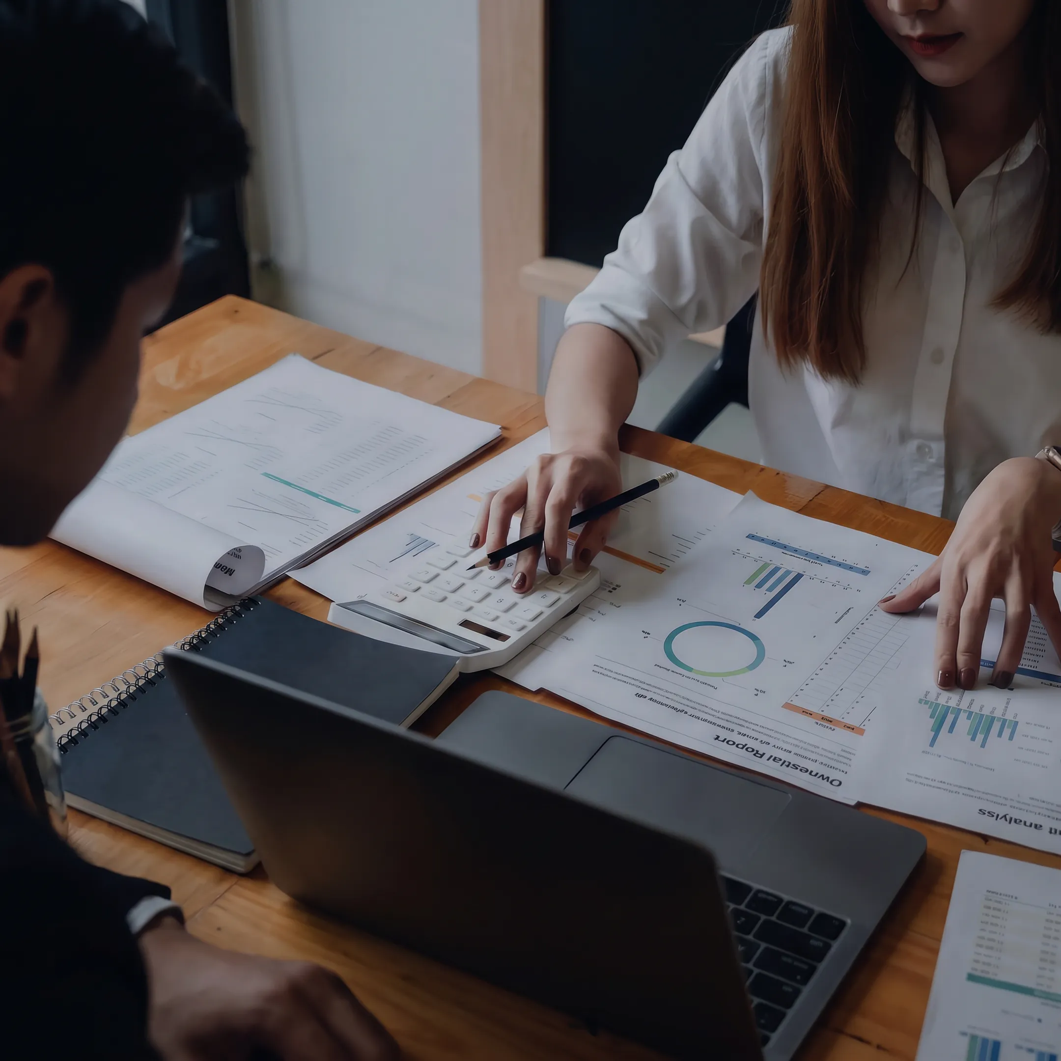Advisor analyzing business valuation documents and financial data