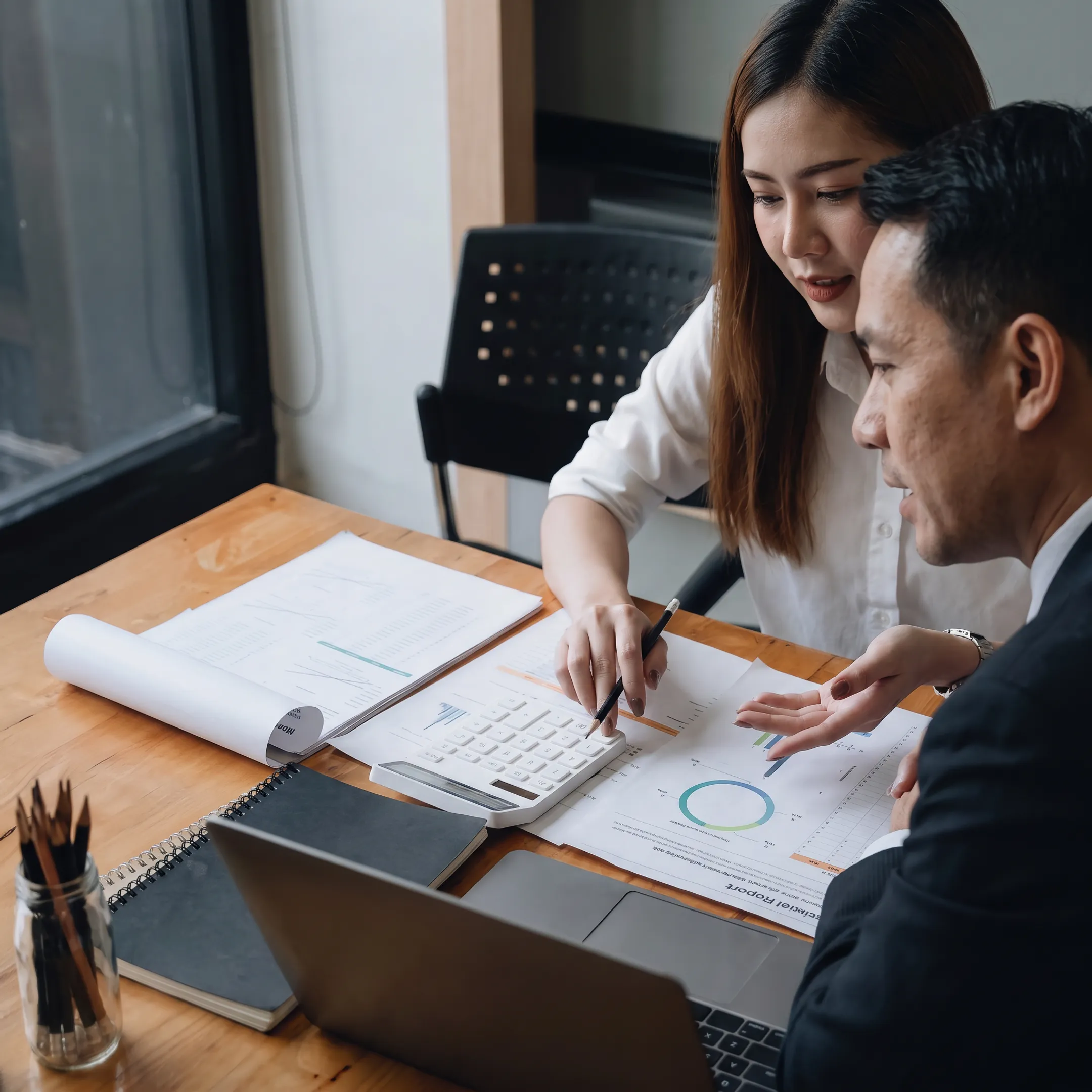 Business valuation professional discussing enterprise value charts with business owner