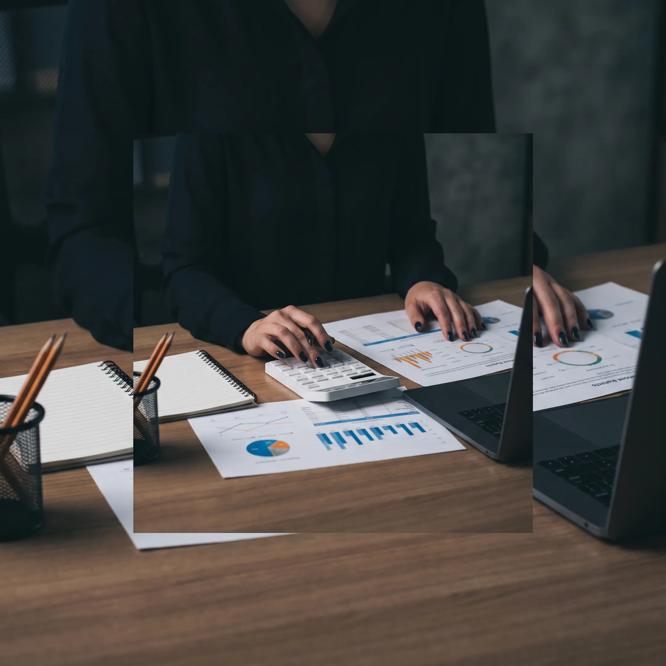 Business valuator reviewing financial documents with a business owner in a professional office