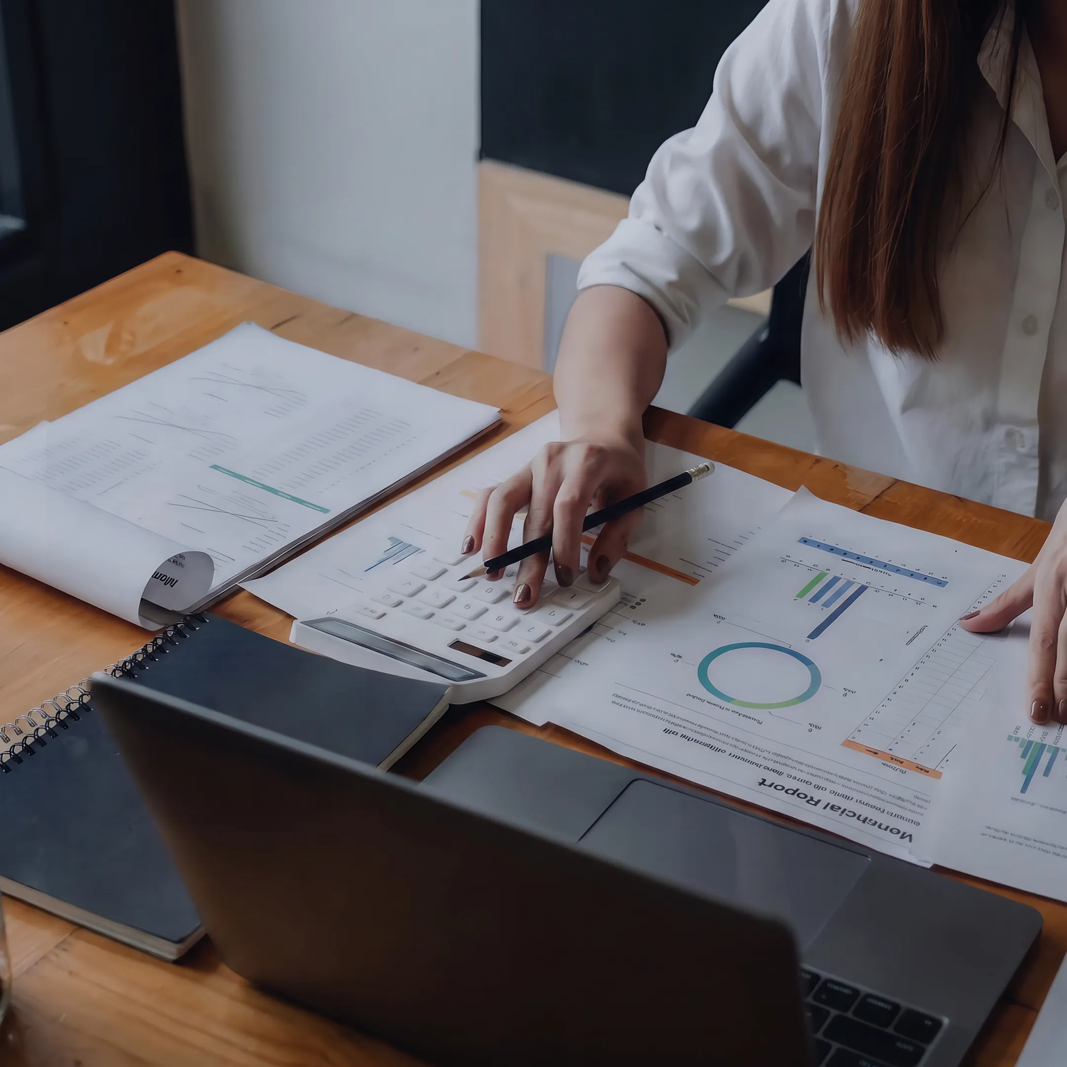 Valuation professional reviewing business financial documents at a desk