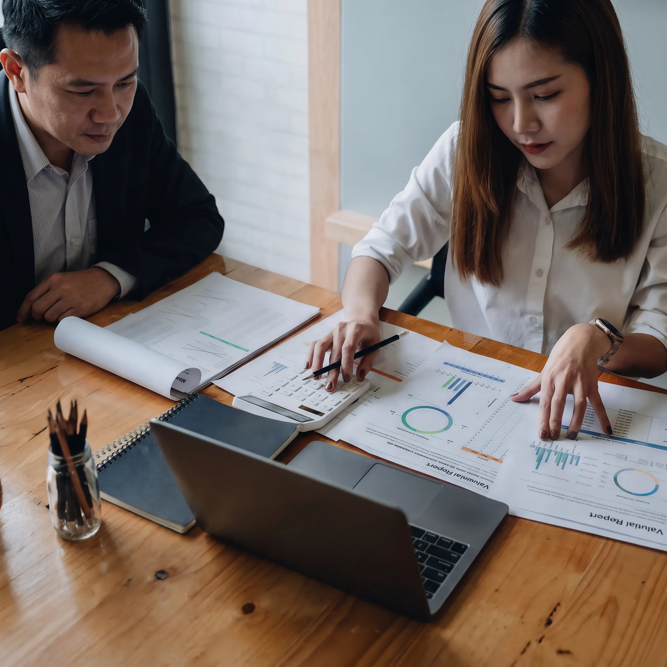 Advisor reviewing business valuation documents with a business owner