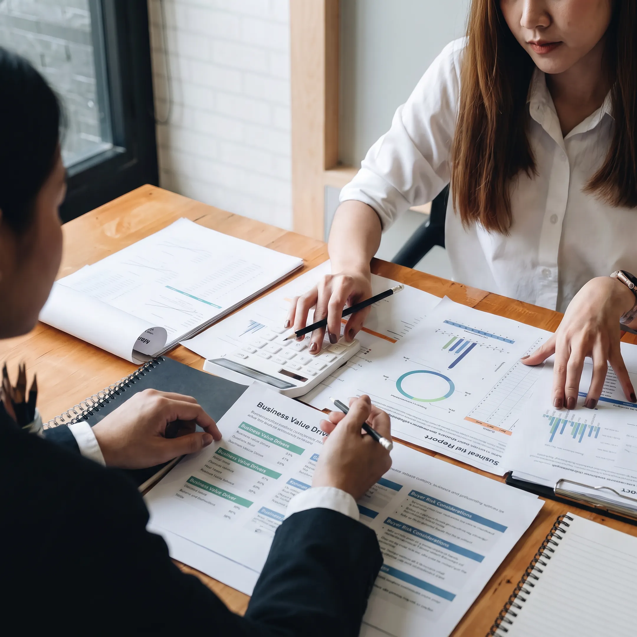 Business owner discussing valuation findings with an M&A adviser