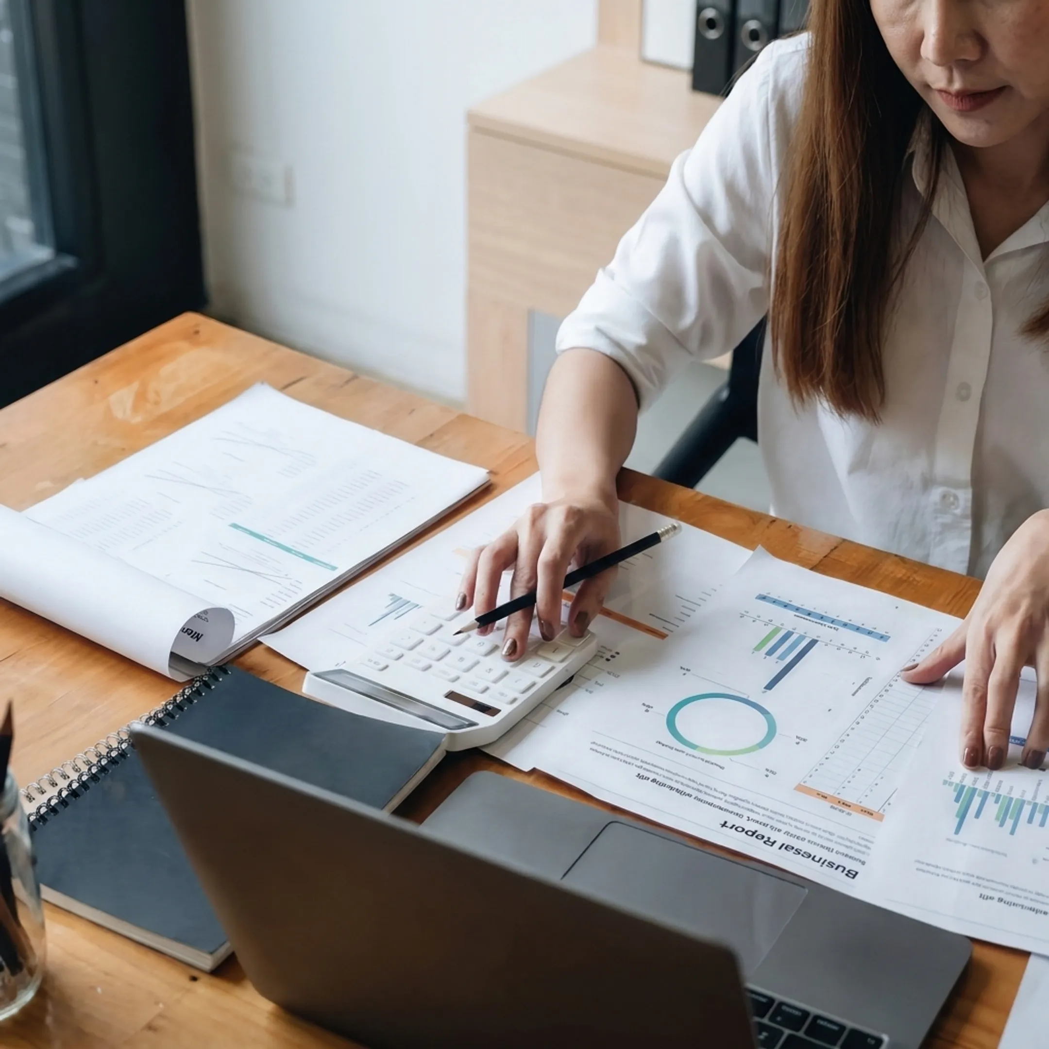 Valuation professional reviewing gift tax documents and business appraisal materials