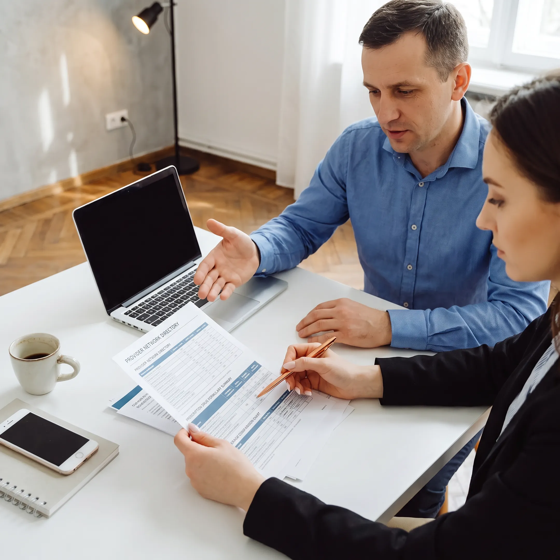 Advisor comparing insurance plans and network details with a client