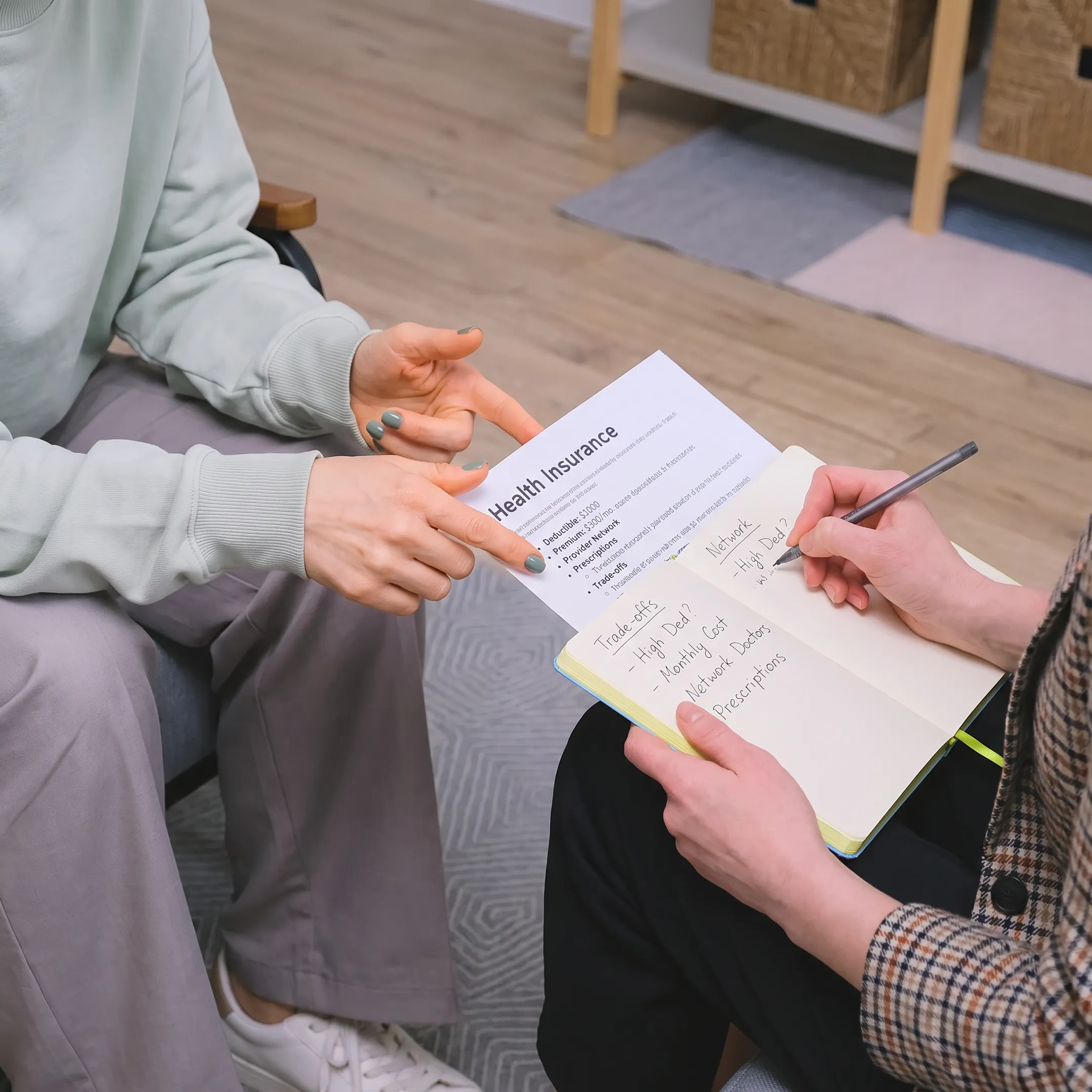 Advisor explaining health insurance plan details to a client