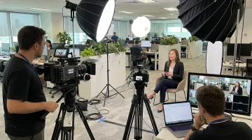 Professional video production crew filming customer testimonial interview on location