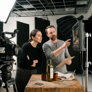 Video production crew reviewing food brand footage