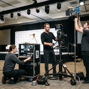 Video crew preparing multi-camera event production equipment
