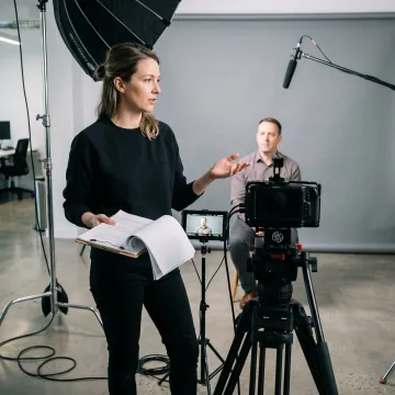 Producer directing an employee interview on set
