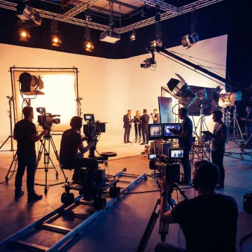 Professional multi-camera video production crew in action during a big budget live event