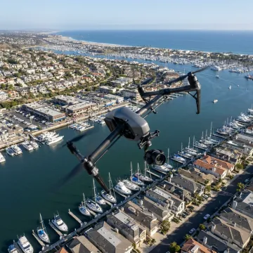 Drone filming aerial video over Newport Beach coastline