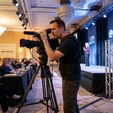 Videographer filming a live corporate event