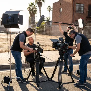 Documentary film crew interviewing a subject in Los Angeles