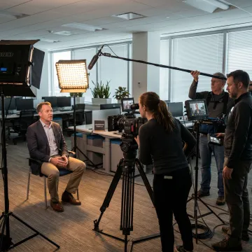 Video team filming a testimonial interview
