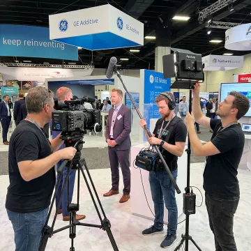 Trade show video crew filming an exhibitor booth