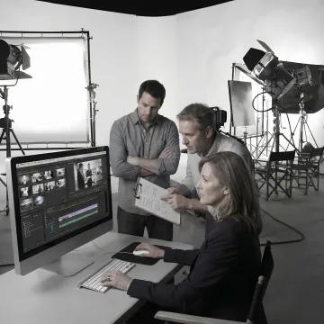 Video production team reviewing footage