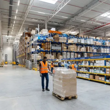 Medical warehouse interior with organized shelving, medical product storage, and fulfillment staff at work