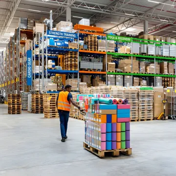 Organized warehouse shelving stocked with sports and fitness equipment ready for order fulfillment
