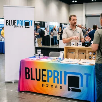 Branded table cover at a trade show booth