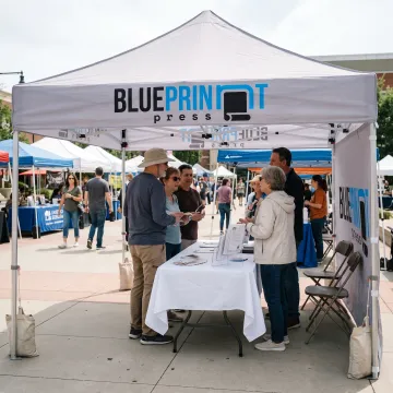 Branded 8x8 pop up canopy tent at an outdoor event
