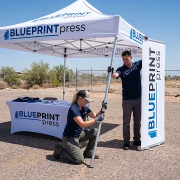 Team setting up a branded canopy display