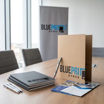 Branded presentation materials arranged on a conference table