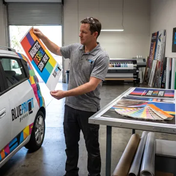 Designer preparing a magnetic car sign