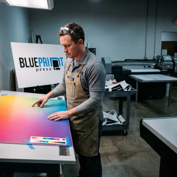 Designer preparing artwork for a foam board sign