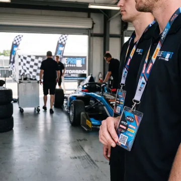 Racing event staff wearing custom lanyards