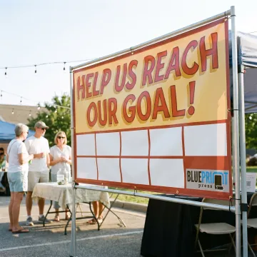 Custom fundraiser banner displayed at a community event