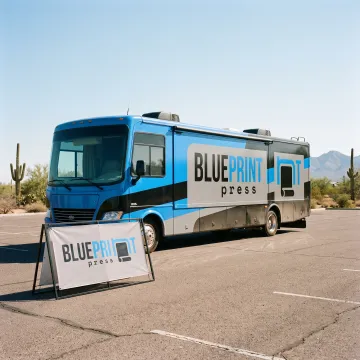 Custom banner and vinyl graphics displayed on an RV