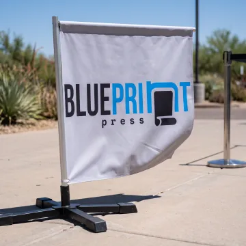 Printed rectangle banner flag beside an event entrance