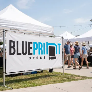 Custom tarpaulin banner displayed at an outdoor event