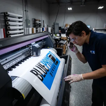 Printer preparing a colorful outdoor banner