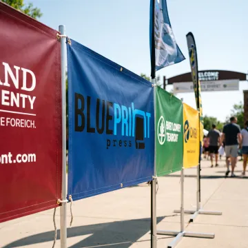 Custom sponsor flags and banners at an outdoor event