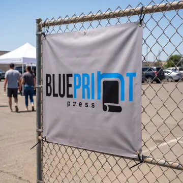 Custom square vinyl banner displayed at an event