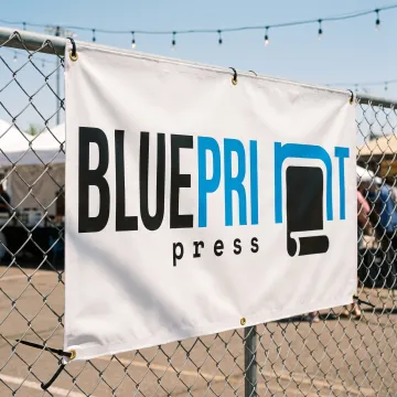 Custom 8x24 vinyl banner displayed outdoors