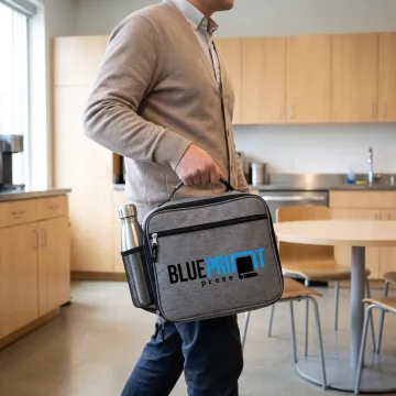 Team member holding a custom printed insulated lunch bag