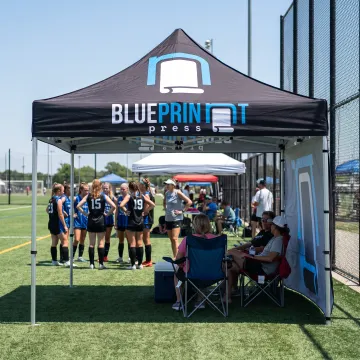 Custom branded sports team canopy tent at an outdoor event