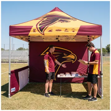 Team staff standing beneath a custom logo canopy tent