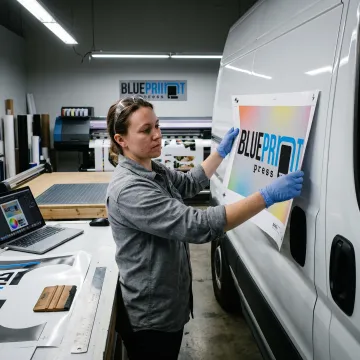Designer reviewing a custom vehicle wrap layout