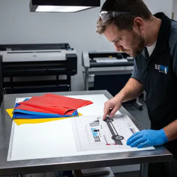 Designer preparing custom vehicle lettering