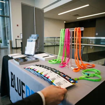 Custom neon lanyards used at an event registration desk
