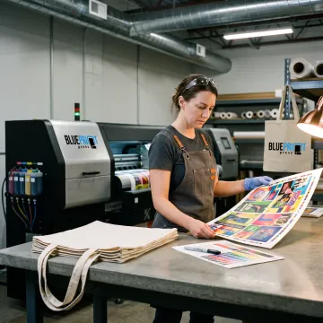 Printer preparing custom tote bag artwork