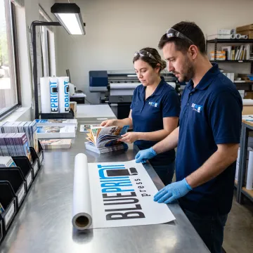 Team preparing printed business materials for production