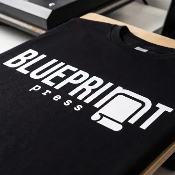 White ink design printed on a black shirt